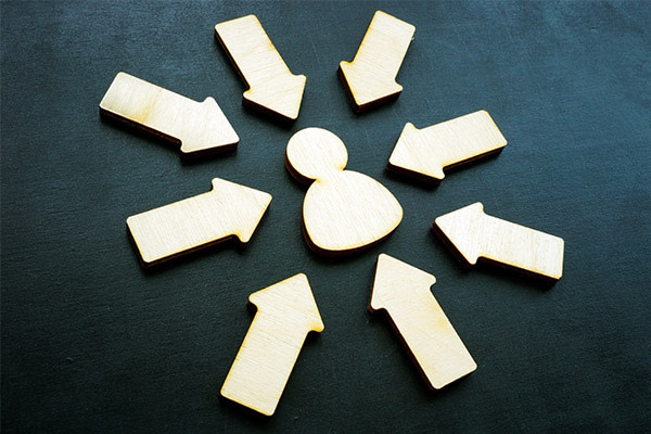 A group of wooden arrows and a snowman on a black background.